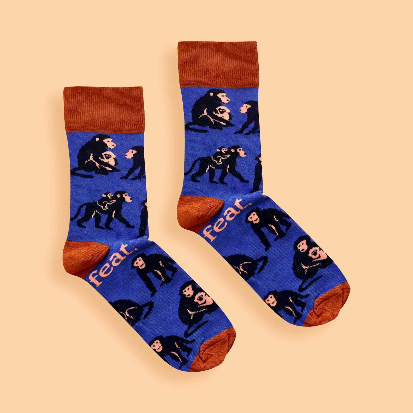 Blue and rust baboon socks on peach background