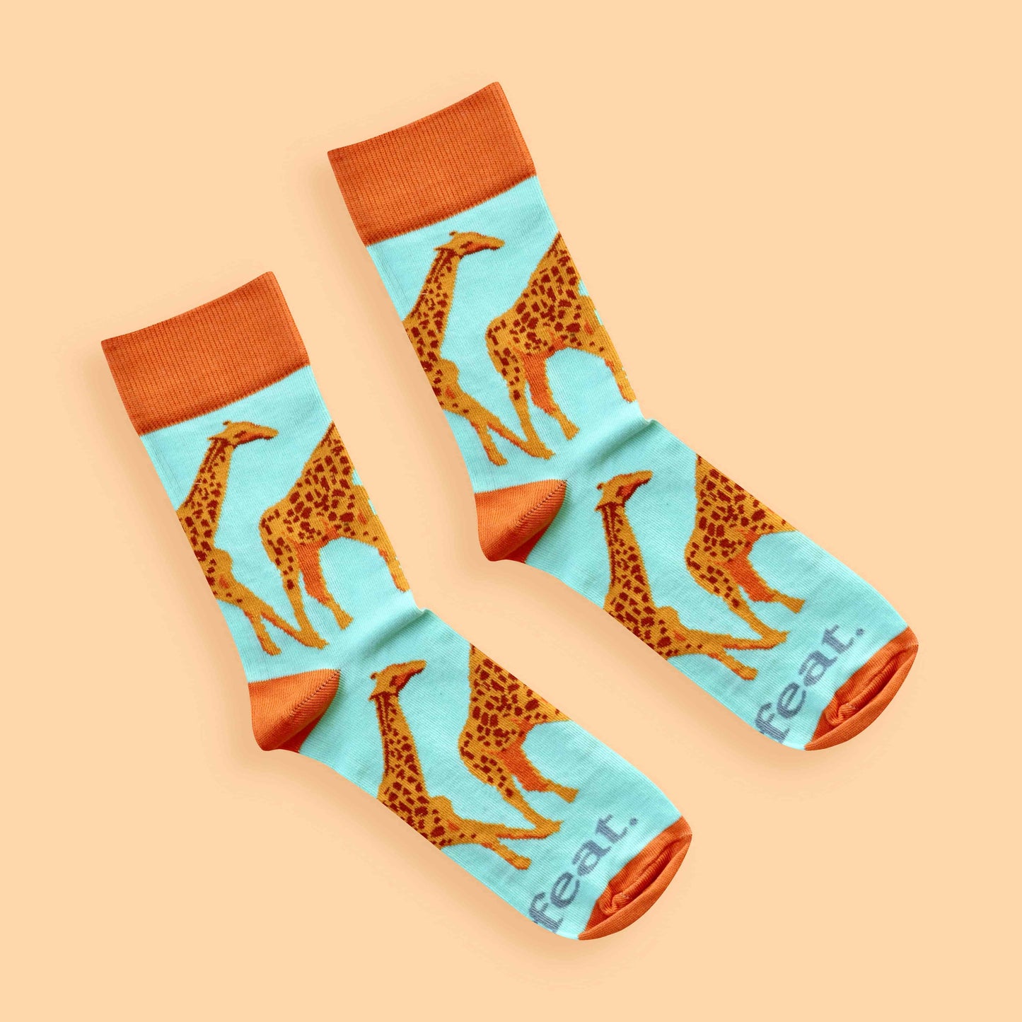 Giraffe socks for ladies on peach background