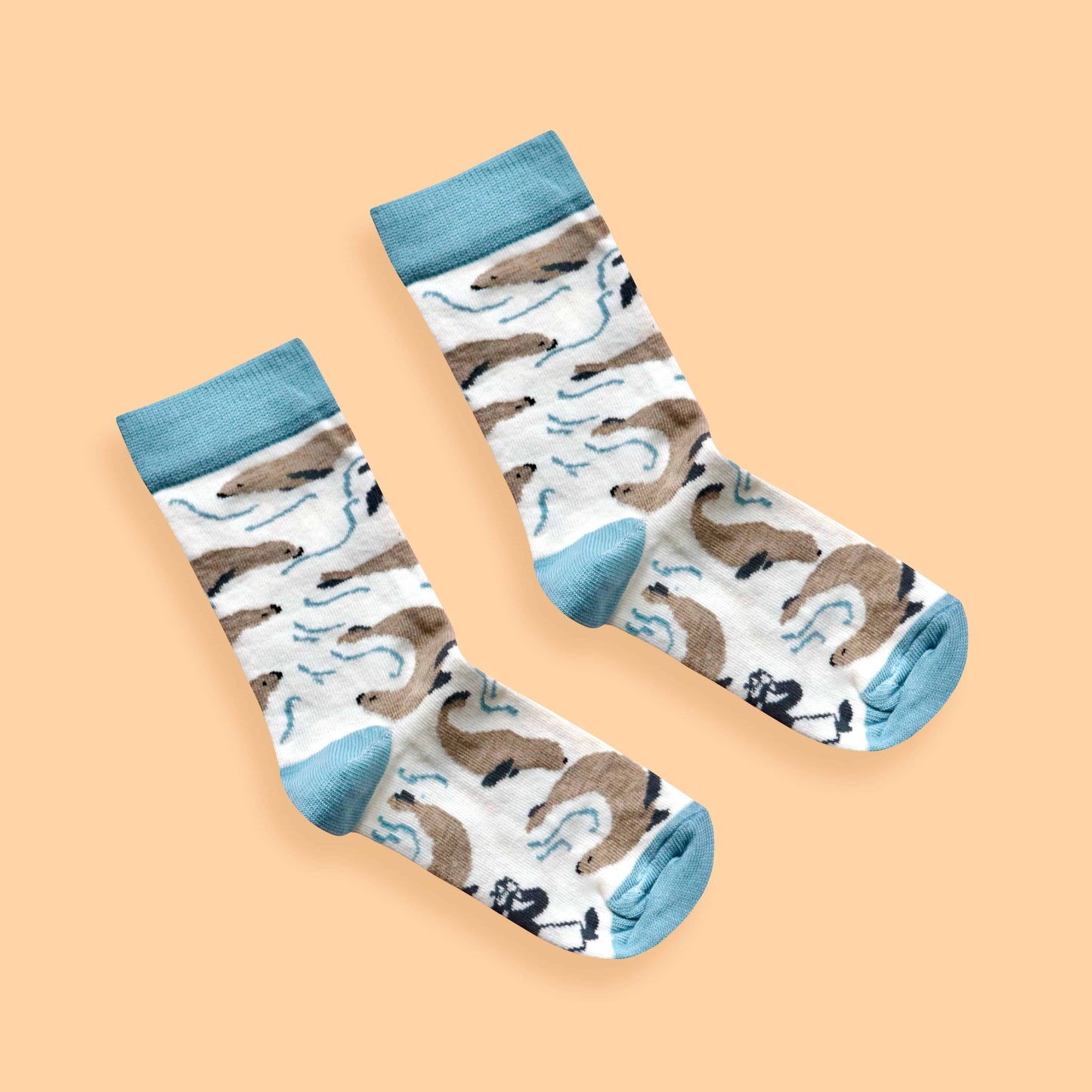 Kids seal socks on orange background diagonal