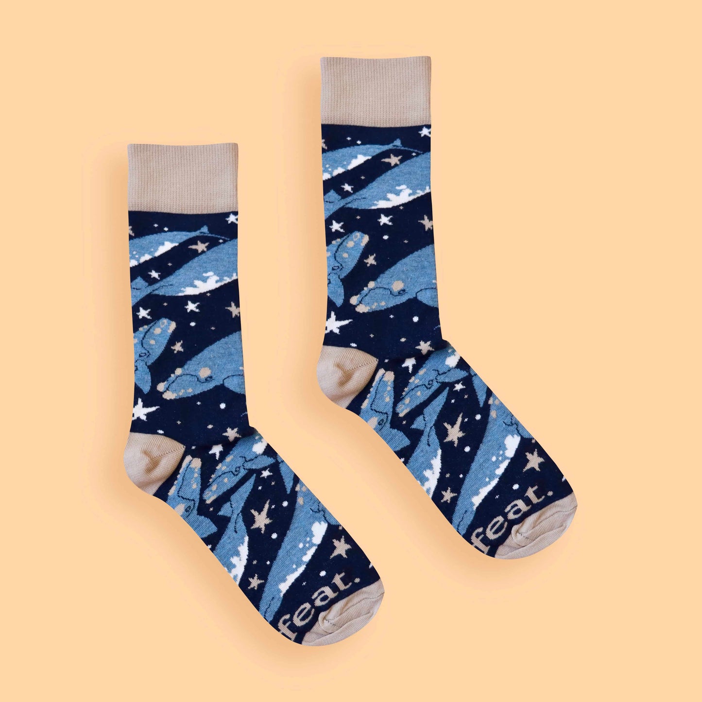 Whale socks peach background centered