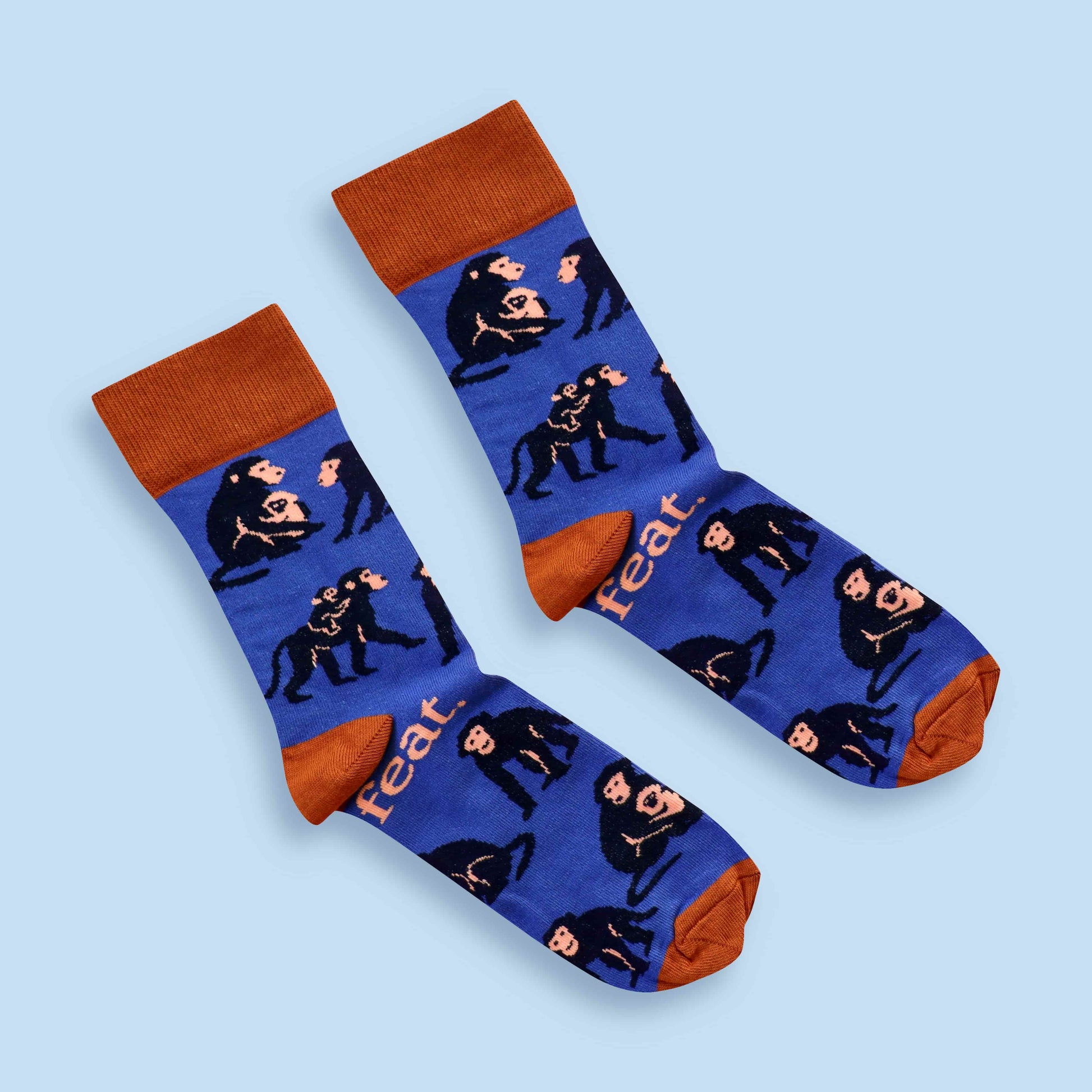 Baboon socks in blue and rust with blue background