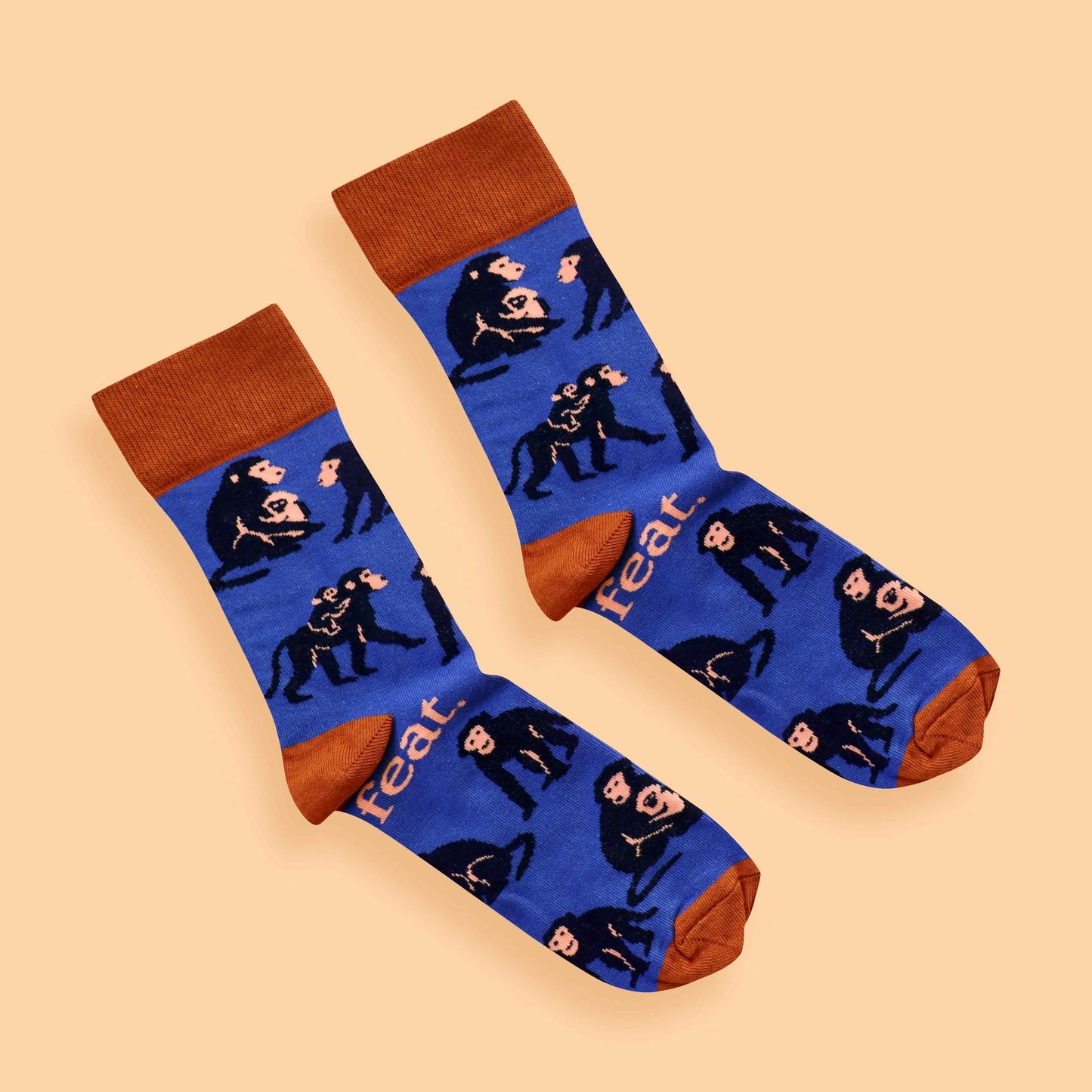 Blue and rust baboon socks on peach background