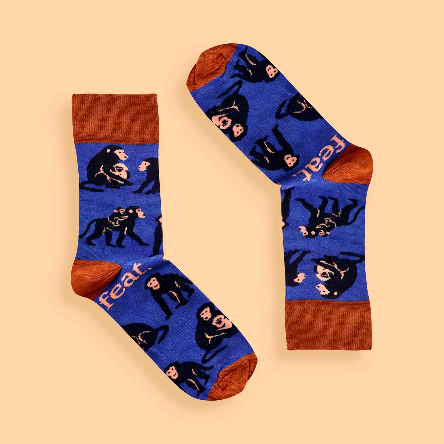 Blue and rust baboon socks on peach background