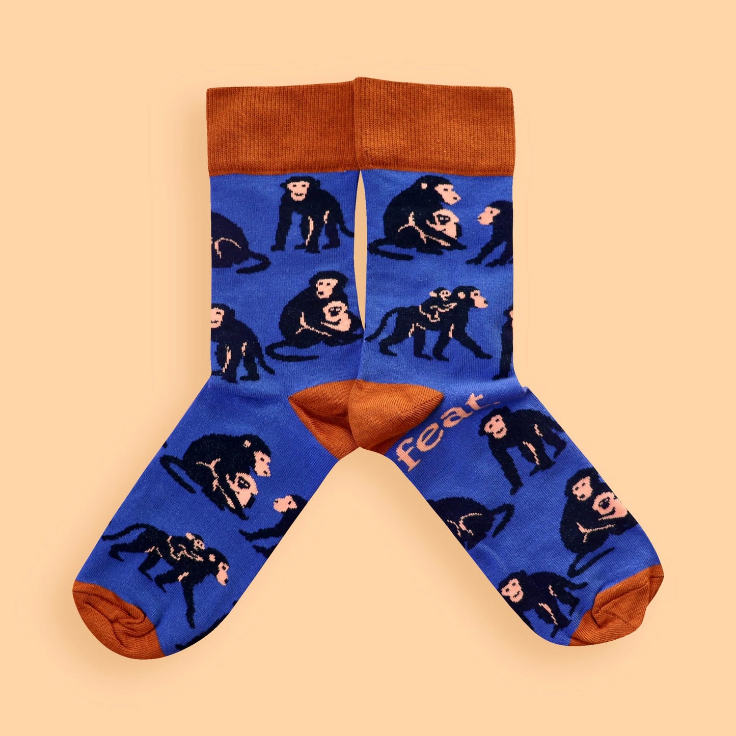 Blue and rust baboon socks on peach background