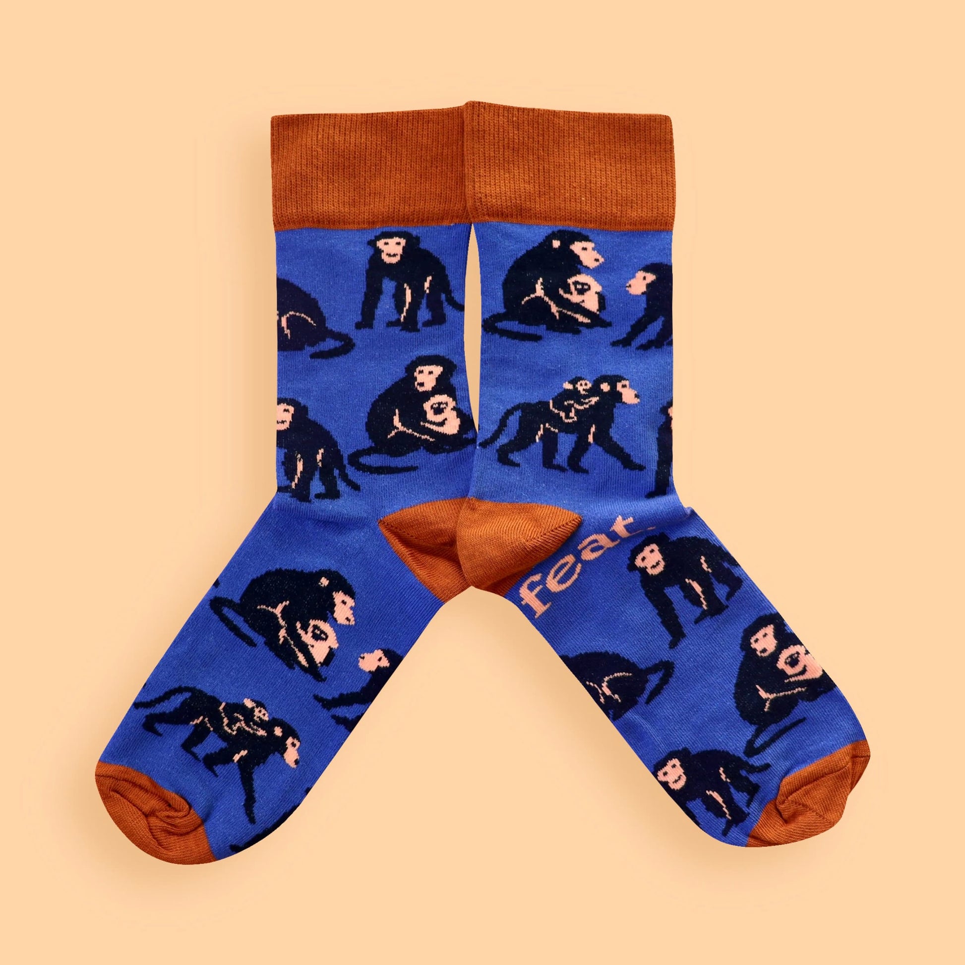 Blue and rust baboon socks on peach background