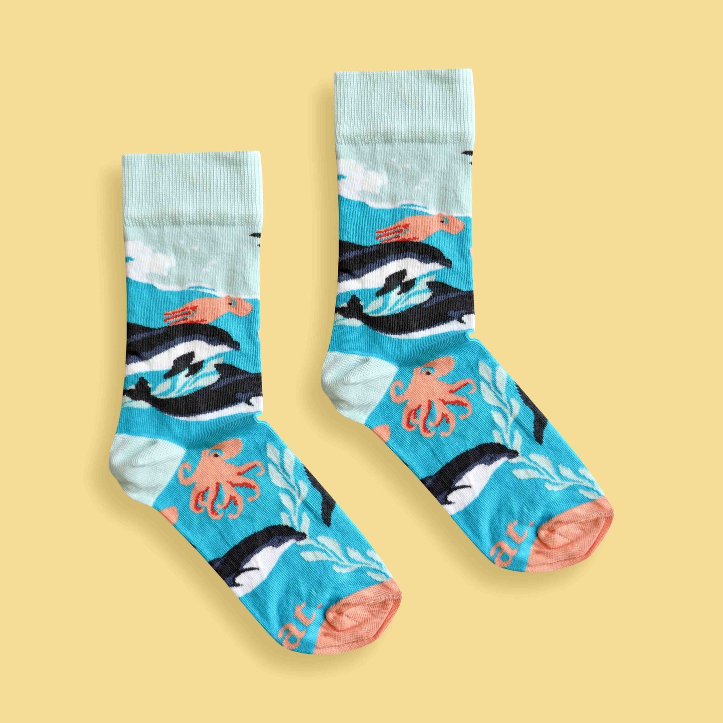 Dolphin party socks yellow background centered