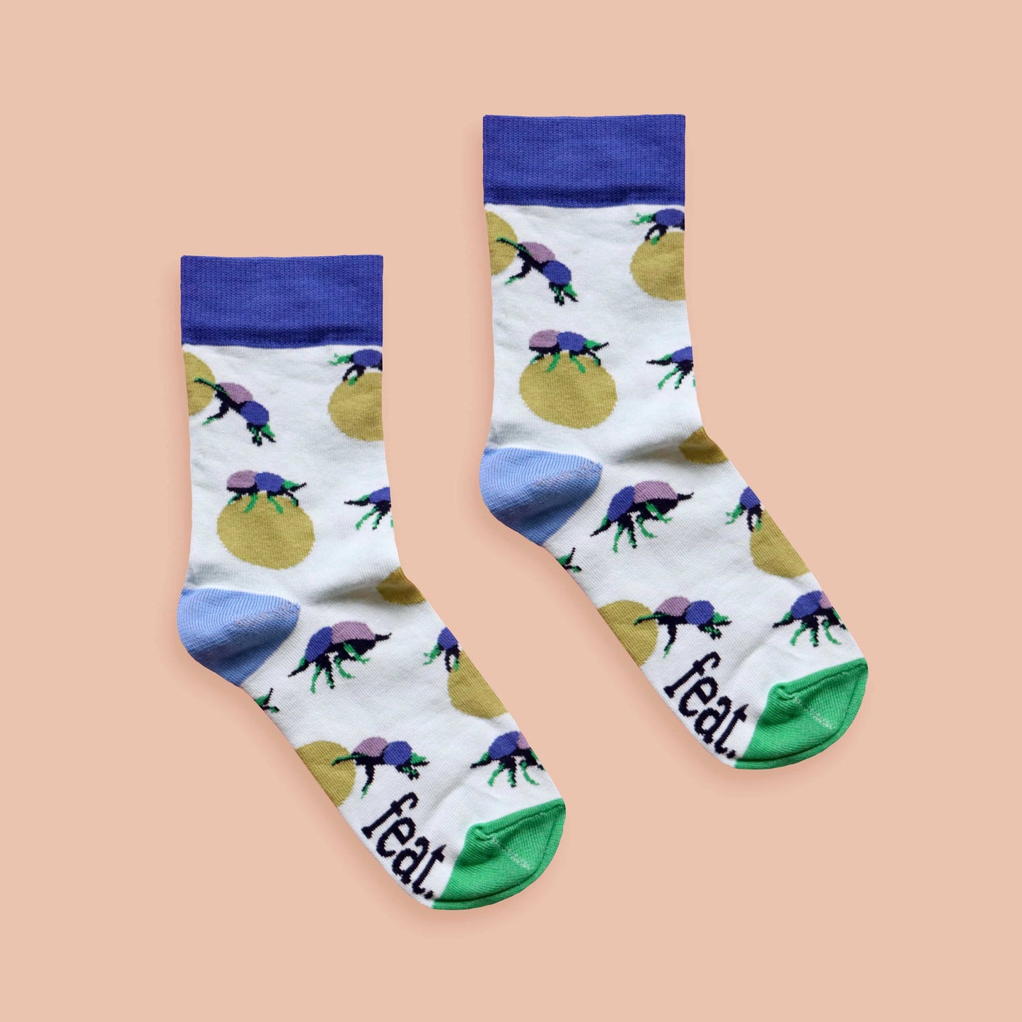Dung beetle socks peach background centered