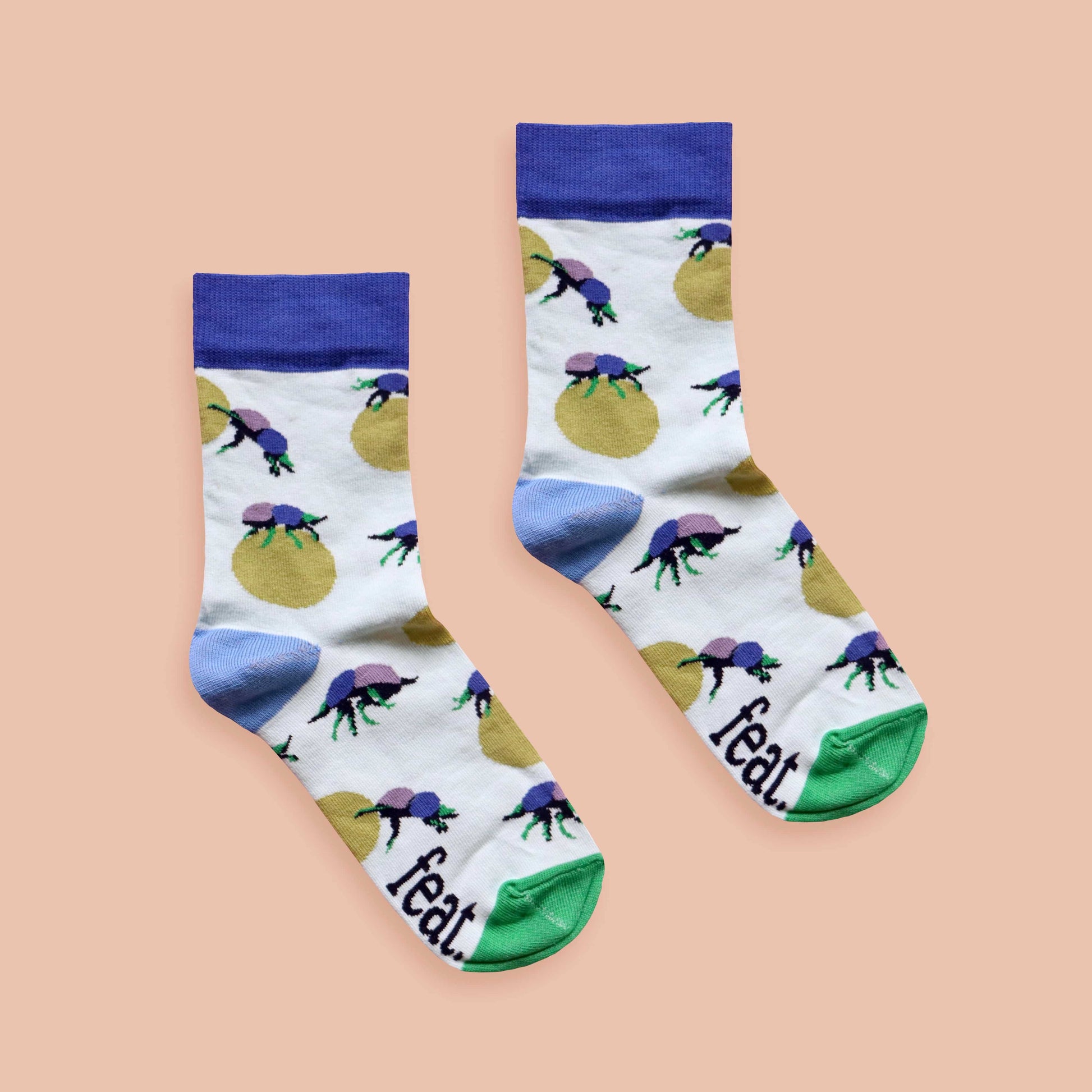 Dung beetle socks peach background centered