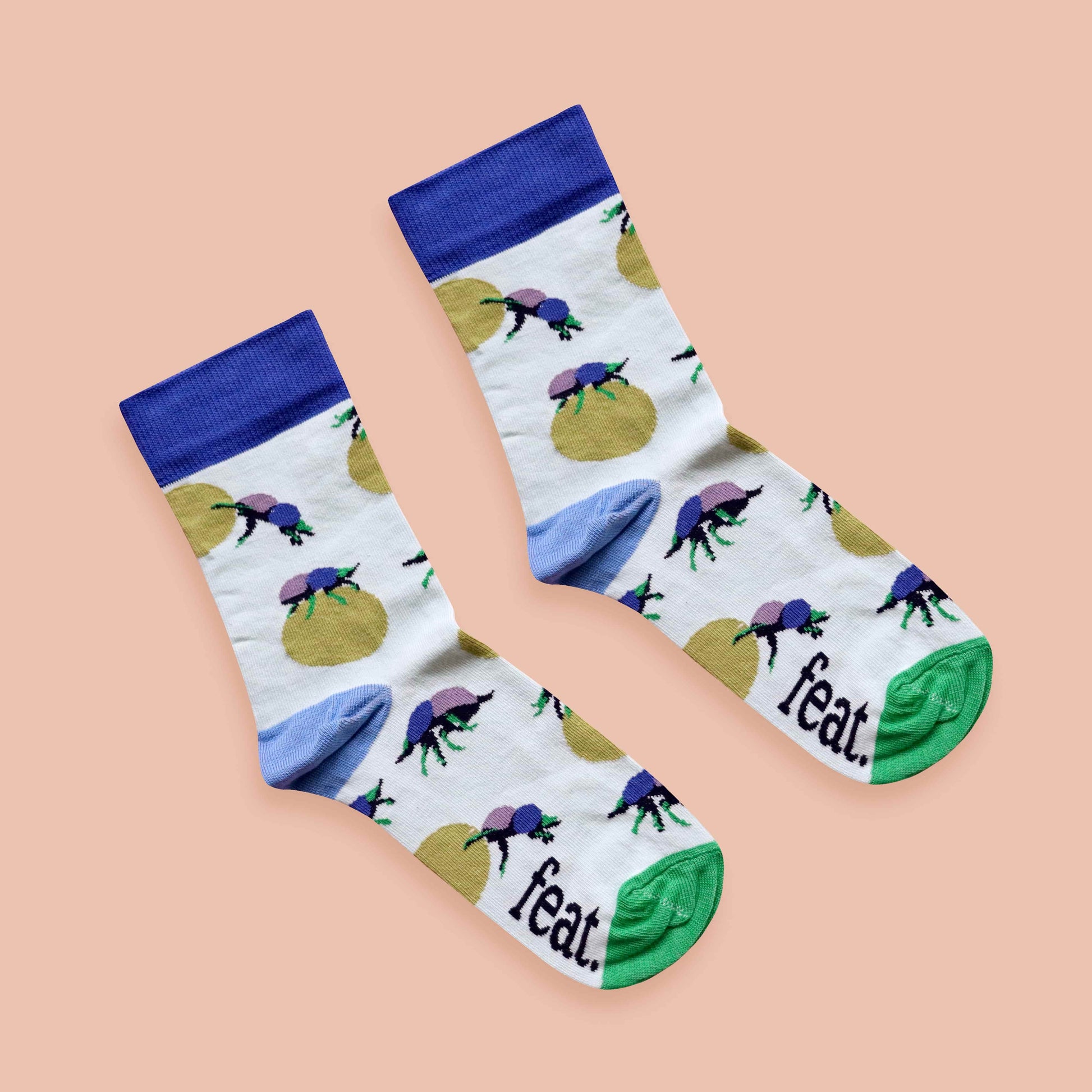 Dung beetle socks peach background diagonal