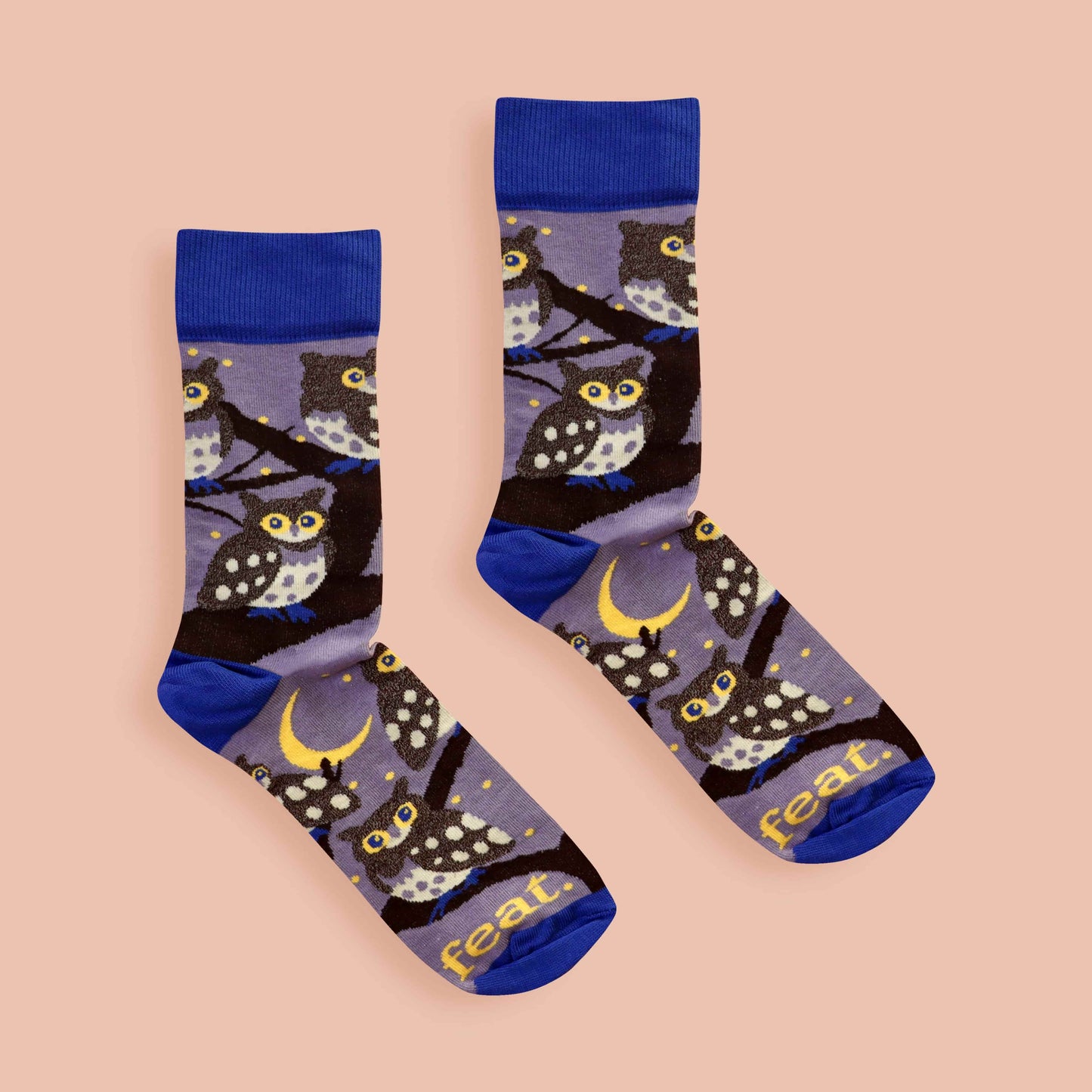 Pair of socks with owl pattern on a beige background