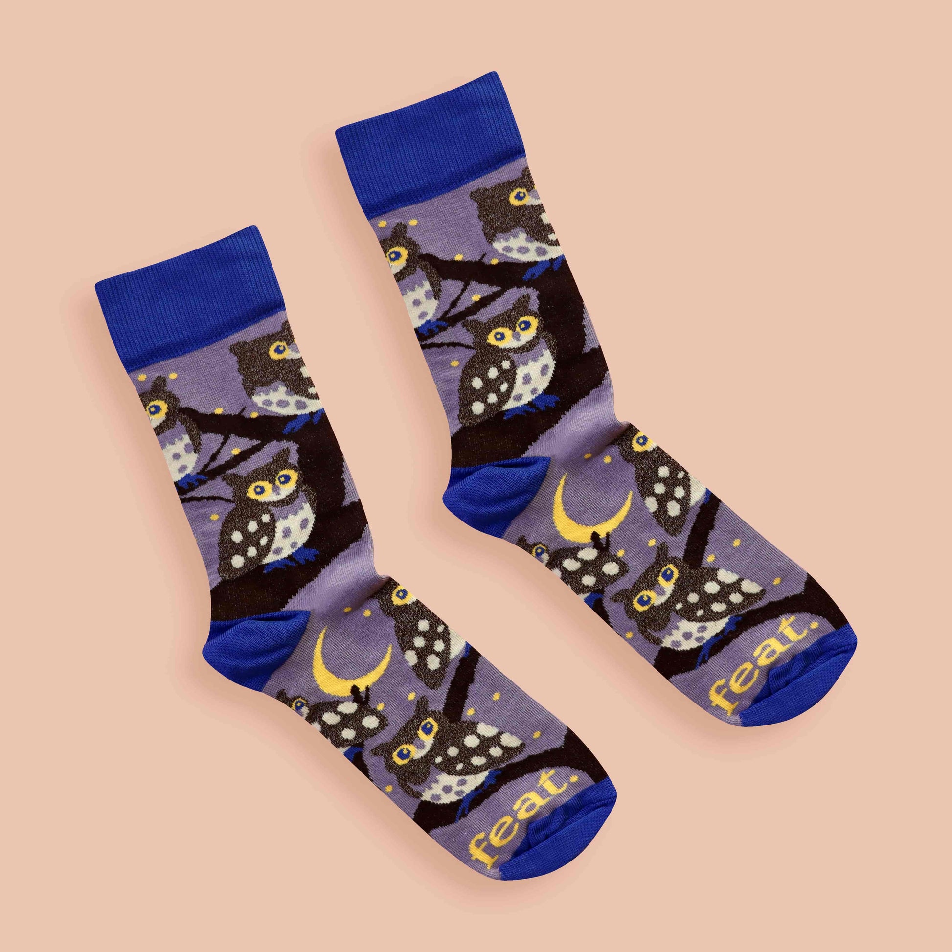Pair of socks with owl pattern on a beige background