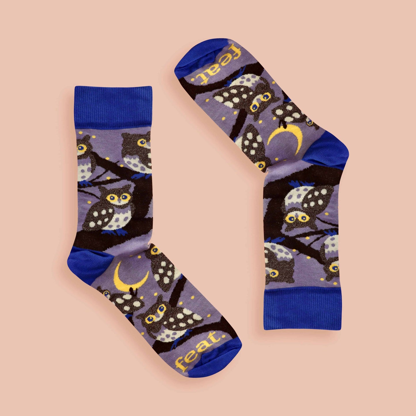 Pair of socks with owl design on a beige background
