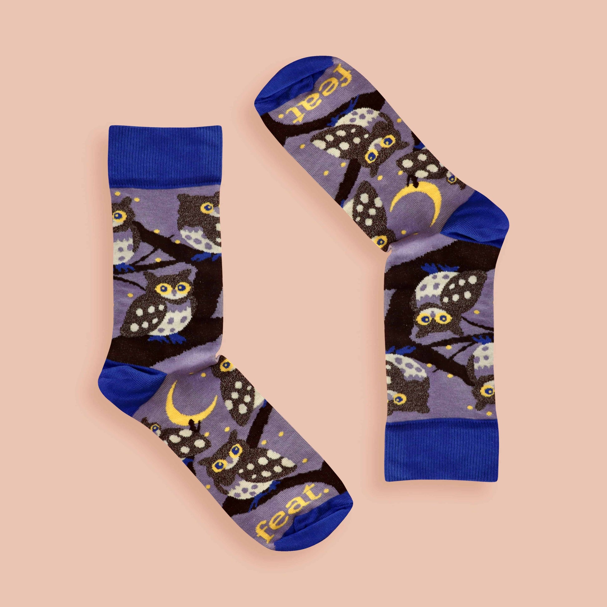 Pair of socks with owl design on a beige background
