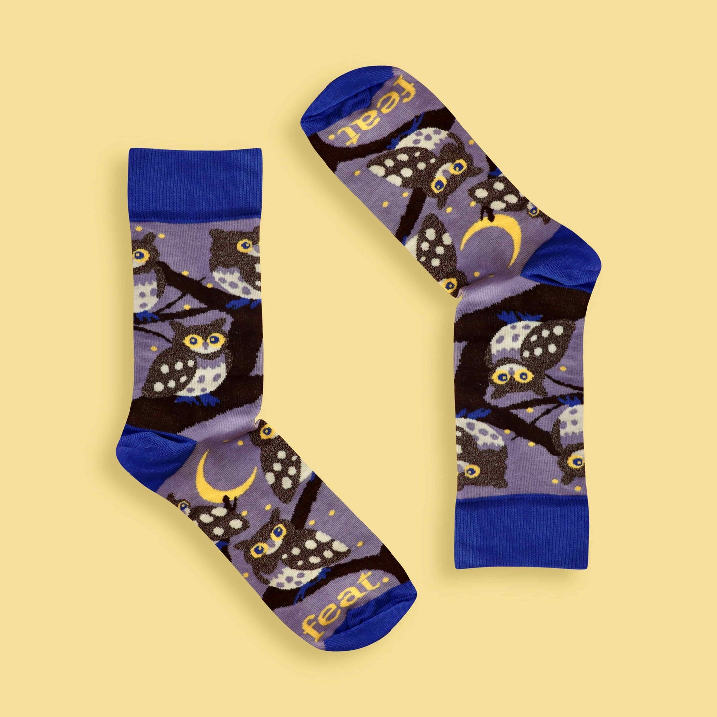Pair of socks with owl design on a yellow background