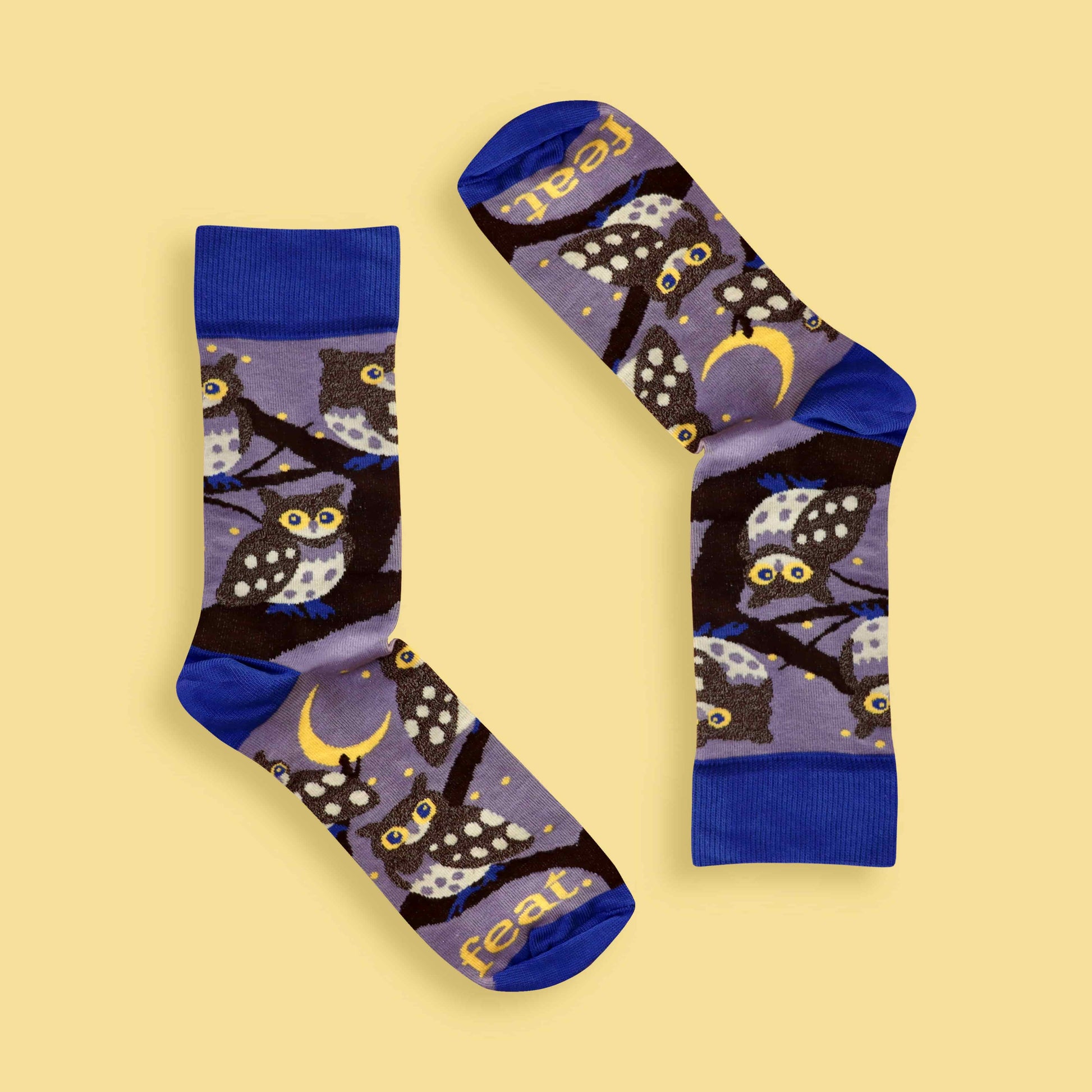 Pair of socks with owl design on a yellow background