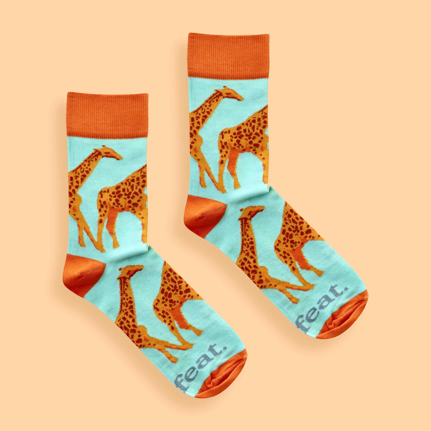 Giraffe socks for ladies on peach background