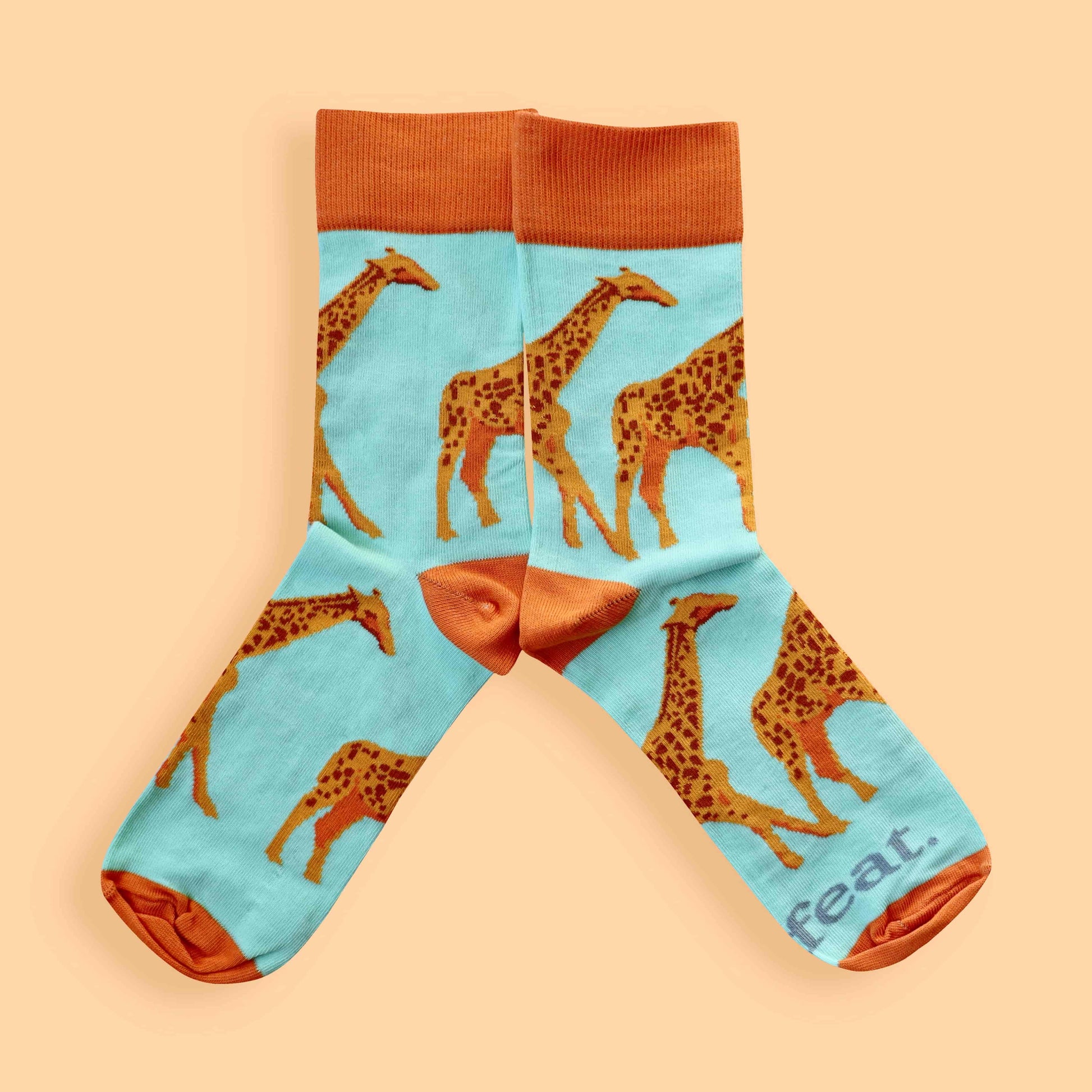 Giraffe socks for ladies on peach background