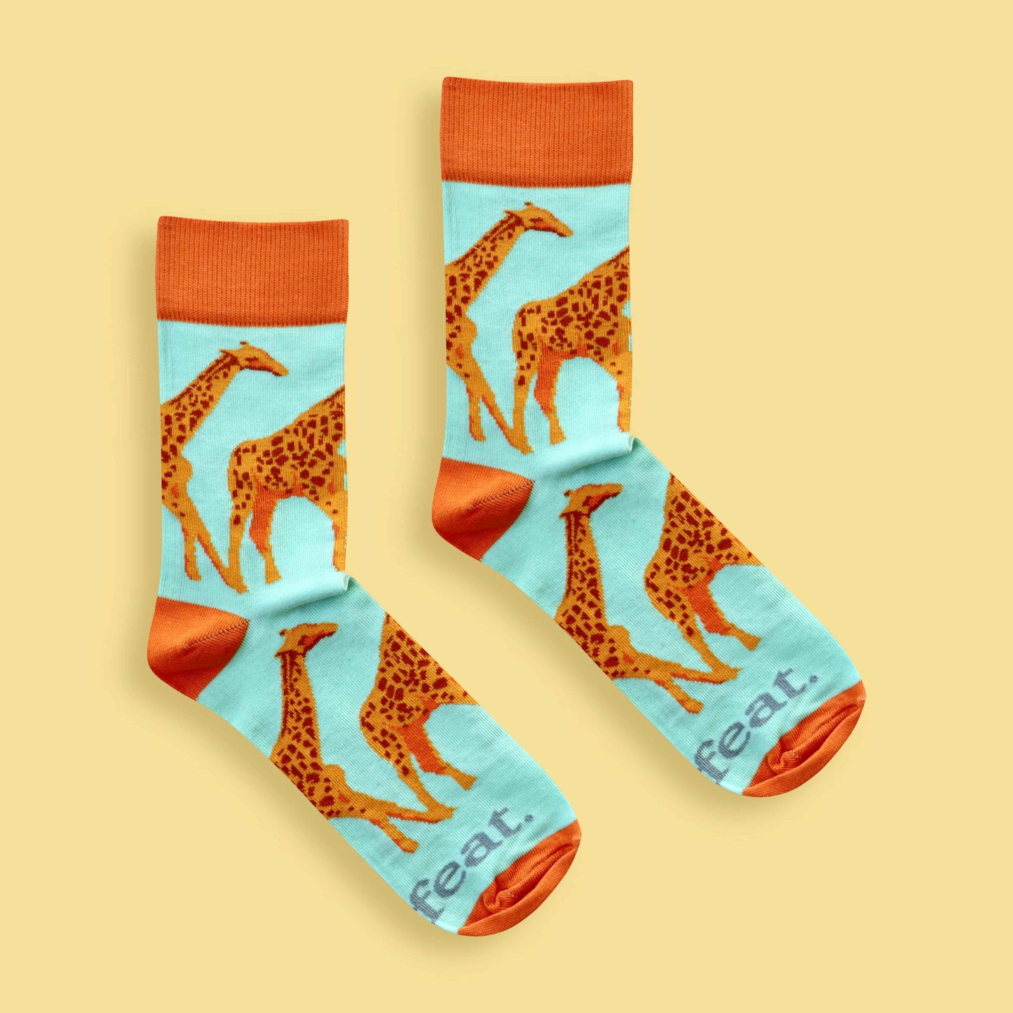 Men’s giraffe socks in green and orange Yellow background 