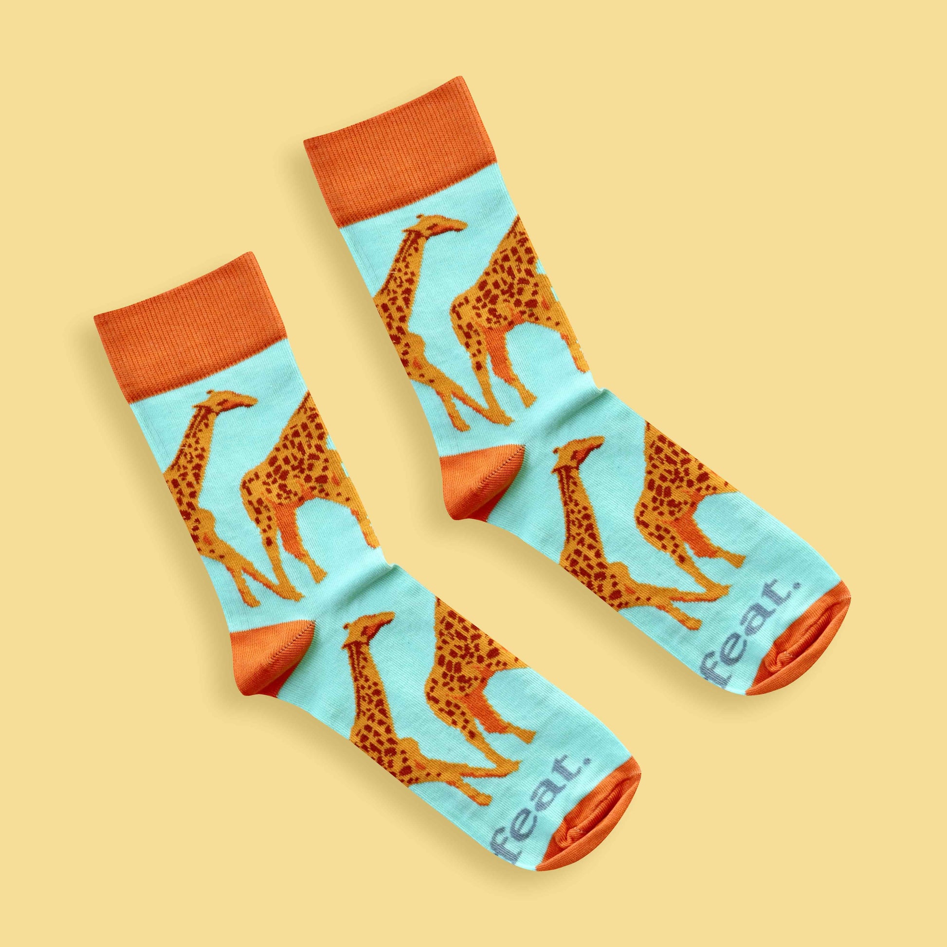 Men’s giraffe socks in green and orange Yellow background 