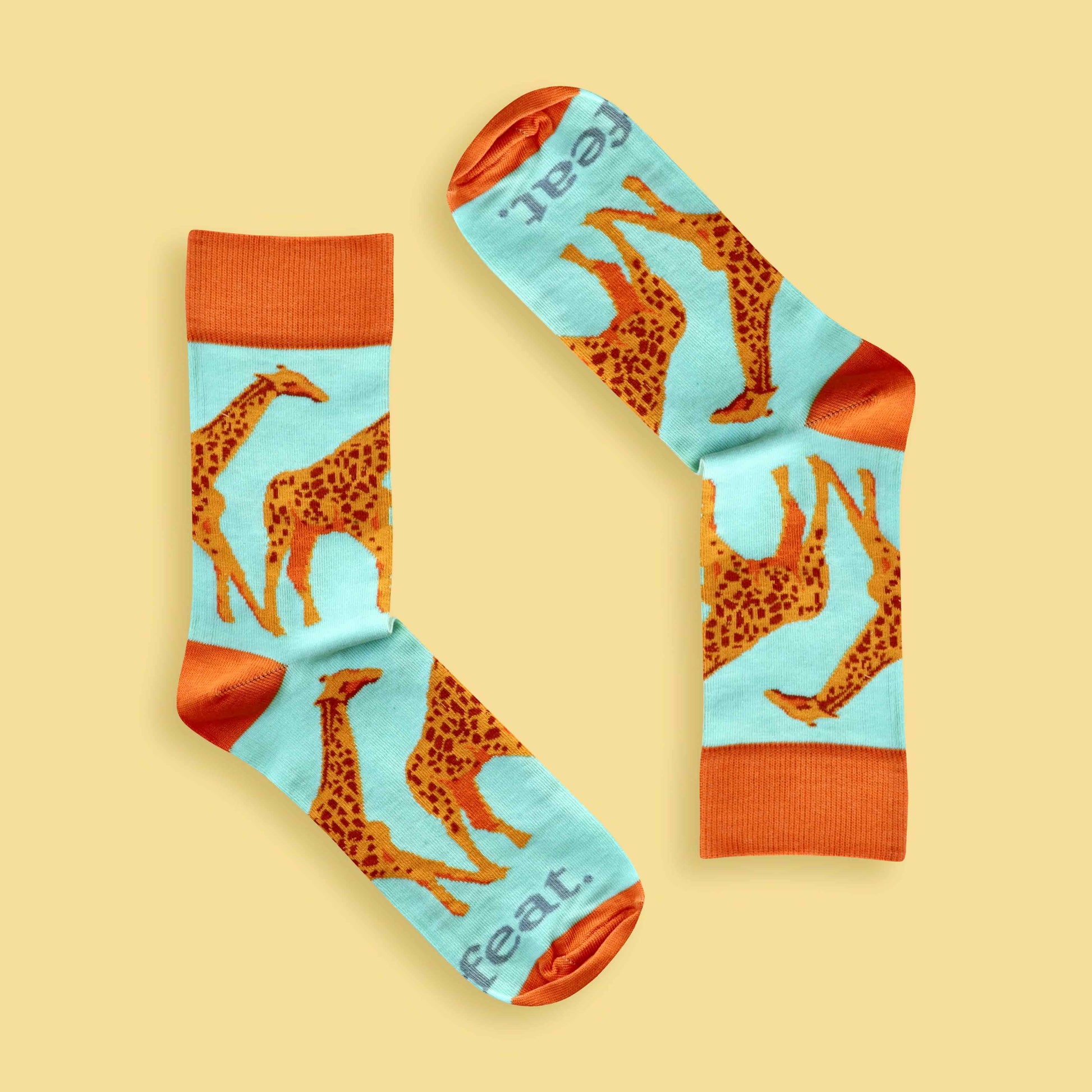 Men’s giraffe socks in green and orange Yellow background 