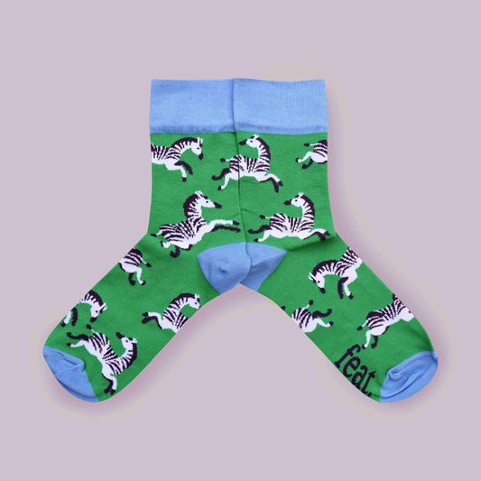 Green zebra socks lilac background mirrored layout