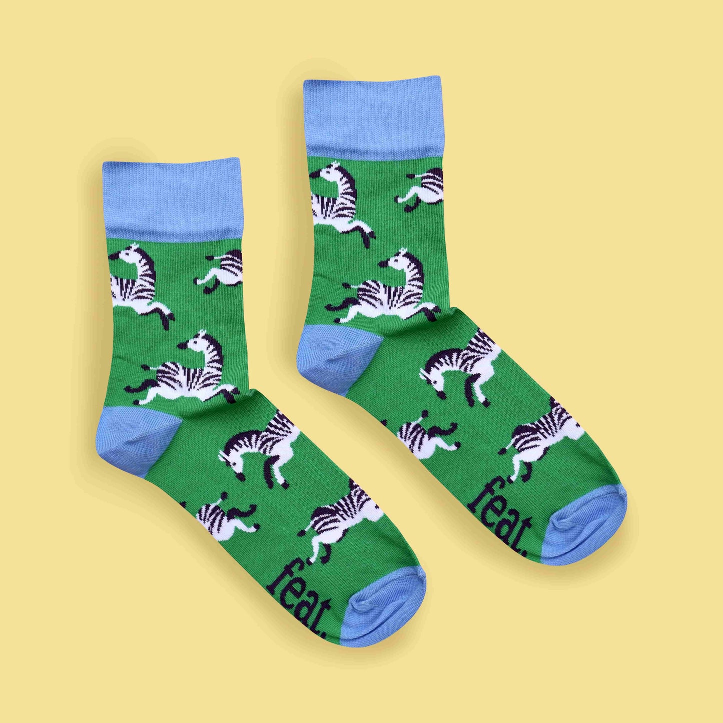 Green zebra socks yellow background centered layout