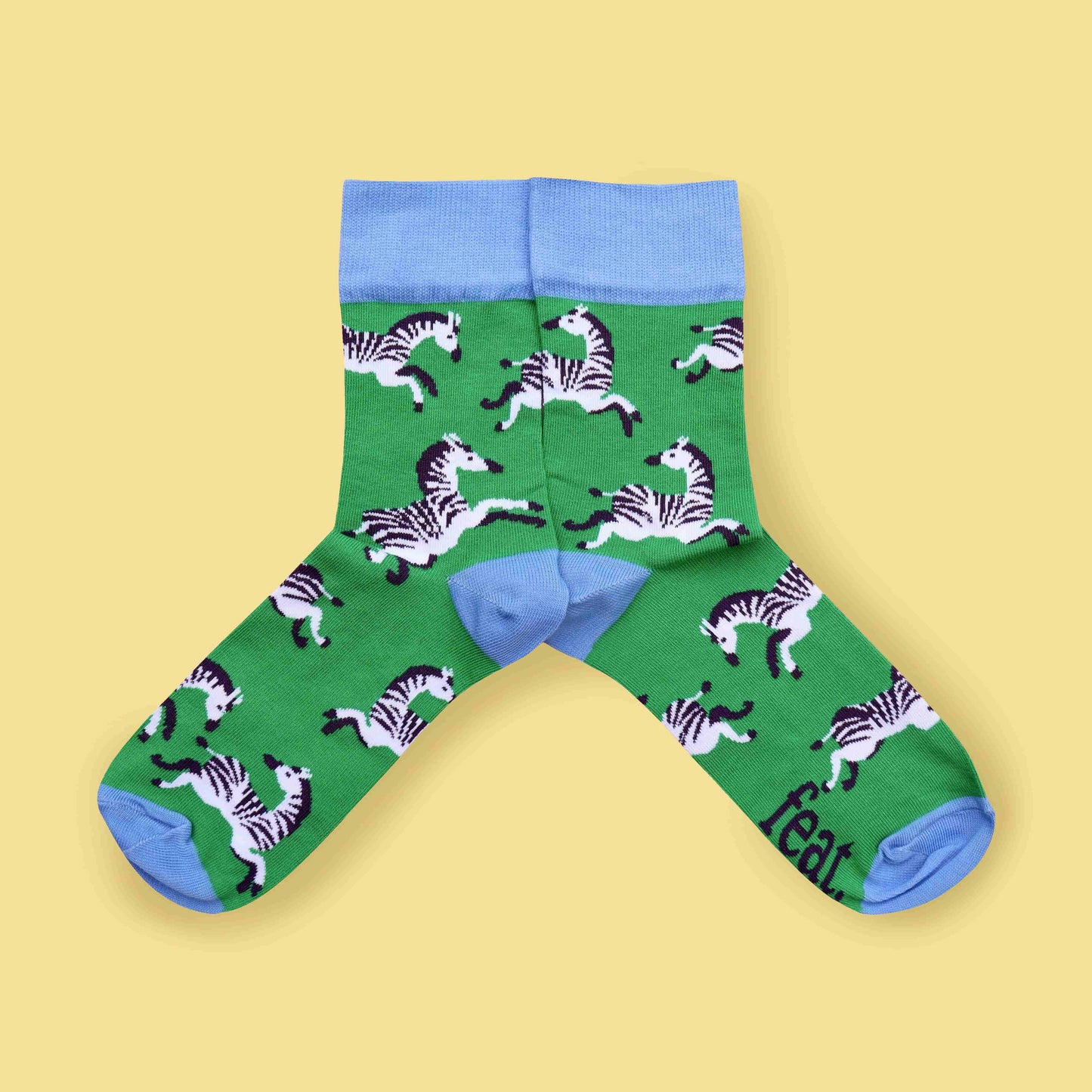 Green zebra socks yellow background mirrored layout