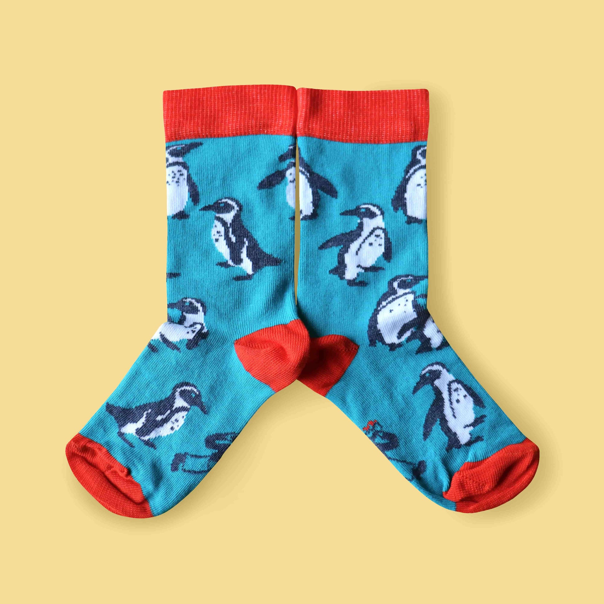 Kids penguin socks yellow background mirrored