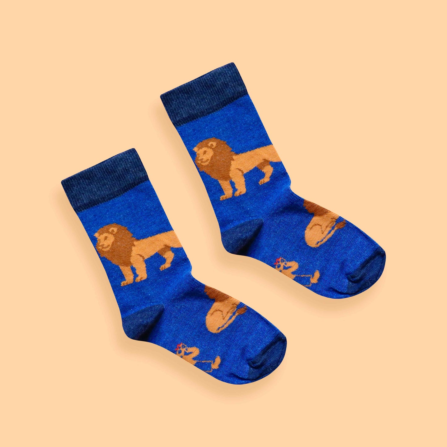 Kids Lion socks peach background diagonal
