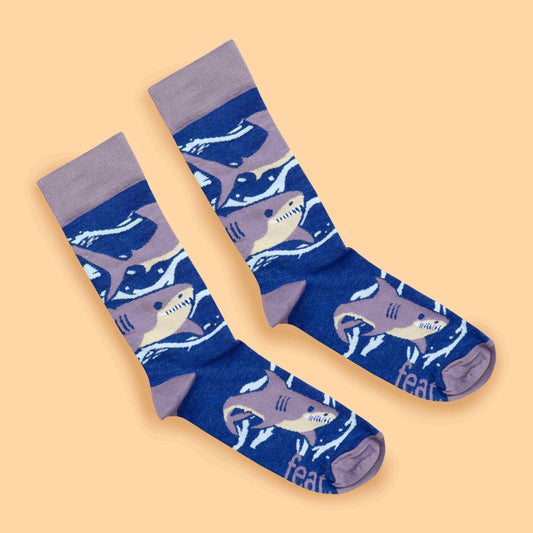 Purple shark socks peach background diagonal layout