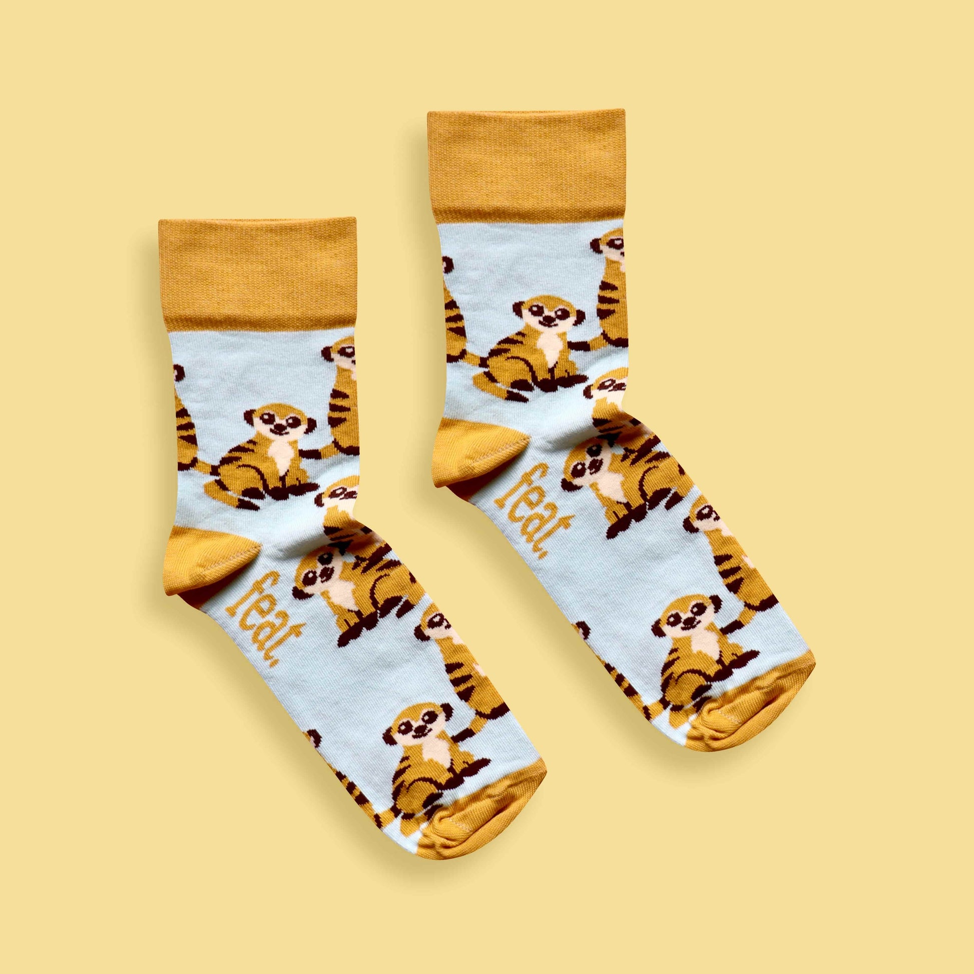 Meerkat socks yellow background centered