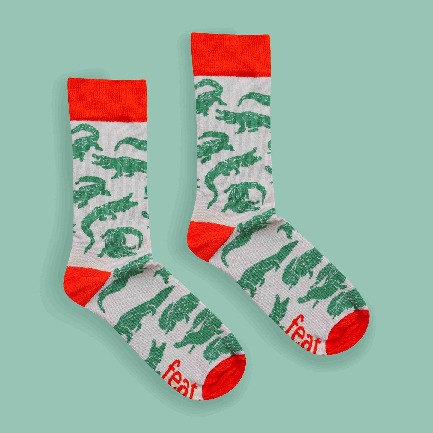 Men’s green and orange crocodile socks green background centered layout