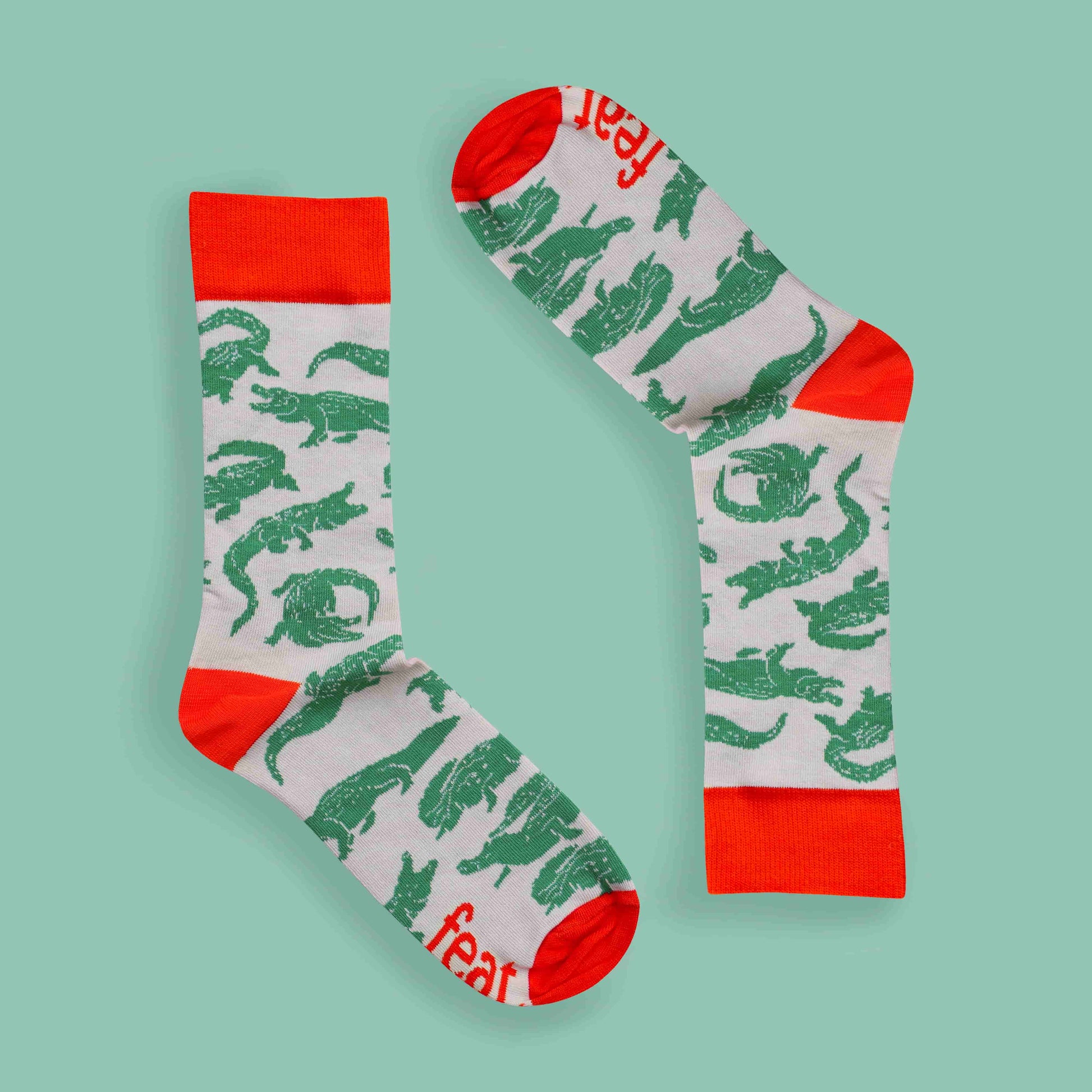 Men’s green and orange crocodile socks green background inverted layout