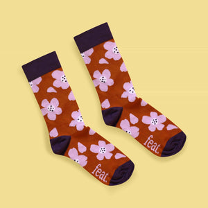 Rust and lilac floral socks diagonal image yellow background
