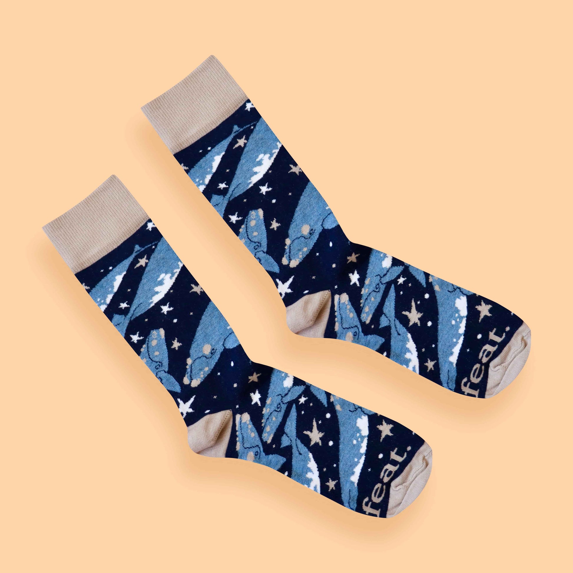 Whale socks peach background diagonal